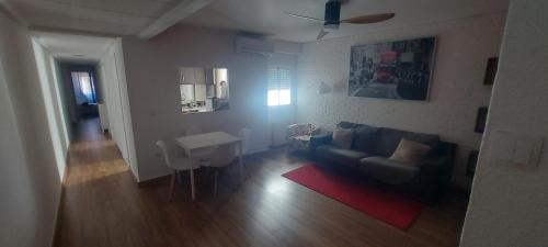 a living room with a couch and a table at Precioso piso-apartamento en barrio de Zaragoza in Zaragoza
