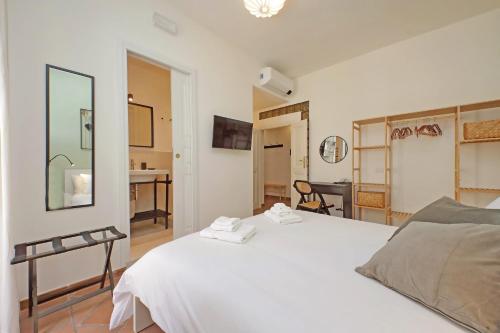 a bedroom with a white bed and a desk at Porta Flaminia Suites in Rome