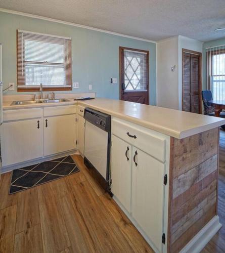 a kitchen with white cabinets and a counter top at Hänsel and Gretel's Hideaway End Unit Parking! in Beech Mountain