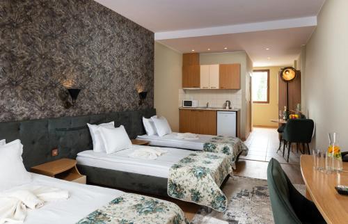 a hotel room with two beds and a table at Hotel Avenue in Sunny Beach