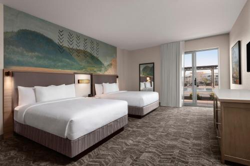 a hotel room with two beds and a television at SpringHill Suites by Marriott Chula Vista Eastlake in Chula Vista