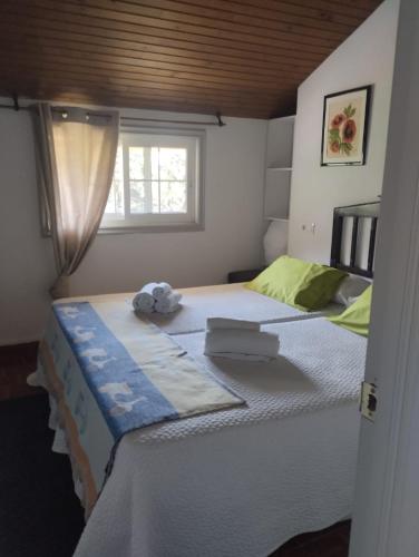 a bedroom with two beds and a window at Aloxamento A Mariña in Oia