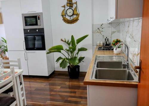 a kitchen with a sink and a stove at Laurent's Durres apartment in Durrës