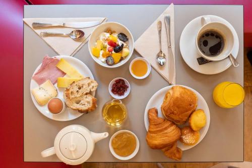 a table with breakfast foods and a cup of coffee at Abou Sofiane Hotel in Port El Kantaoui