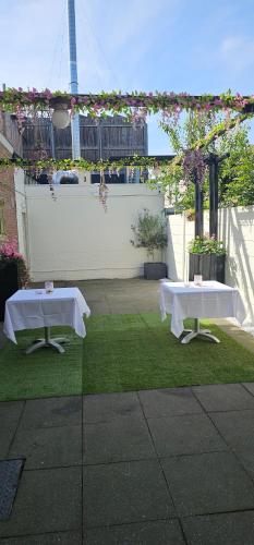 two tables on a lawn with the eiffel tower in the background at Il Mulino House A in Lisse