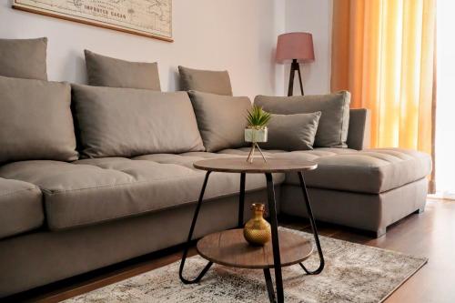 a living room with a couch and a table at Laurent's Durres apartment in Durrës