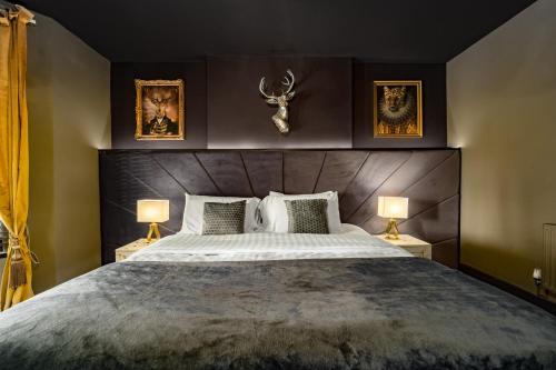 a bedroom with a large bed with two lamps at City Retreat, Spacious 4 Bed House, Games Room, Parking, Hot Tub & BBQ in Cardiff