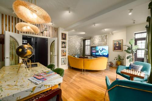 a living room with a table and chairs at City Retreat, Spacious 4 Bed House, Games Room, Parking, Hot Tub & BBQ in Cardiff