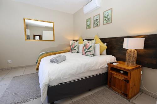 a bedroom with a large bed and a mirror at Hhusha Hhusha in Malelane