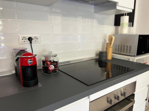 a kitchen with a red appliance on a counter at Casa Stewart - Ponente in Geremèas