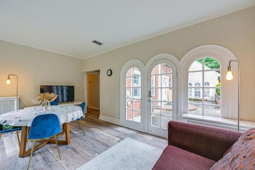 a living room with a table and a couch at Walk to Harbor! Historic Mamaroneck Guest House in Mamaroneck