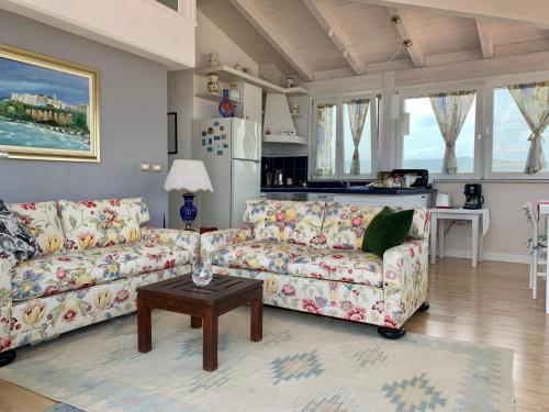 a living room with two couches and a table at Dreaming Penthouse in Vieste