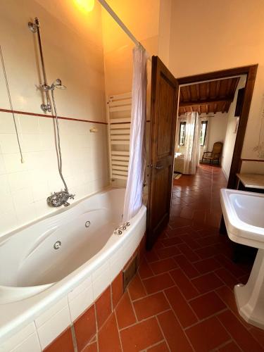 a bathroom with a tub and a toilet and a sink at Podere Sole in Trequanda