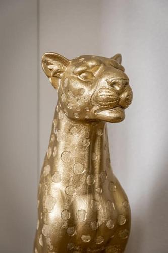 a gold statue of a cat on a wall at Geneva Luxury Stay in Gaillard