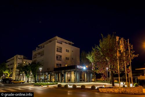 a building on the side of a street at night at Apartman Andrijanic in Grude