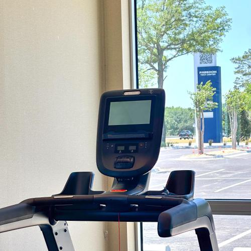 a tv sitting on a shelf next to a window at Home2 Suites by Hilton Fort Walton Beach Eglin AirForce Base in Fort Walton Beach