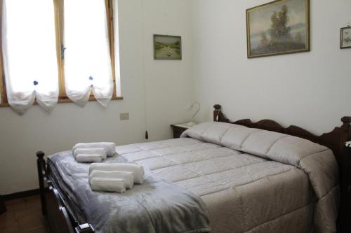 a bedroom with a bed with towels on it at LA TANA DI TONY in Viterbo