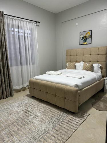a bedroom with a large bed in a room at JnB Naivasha town 1Bedroom in Naivasha