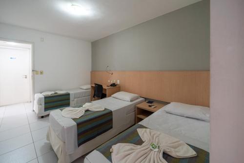 a hotel room with two beds in a room at Lagoa Park Hotel in João Pessoa