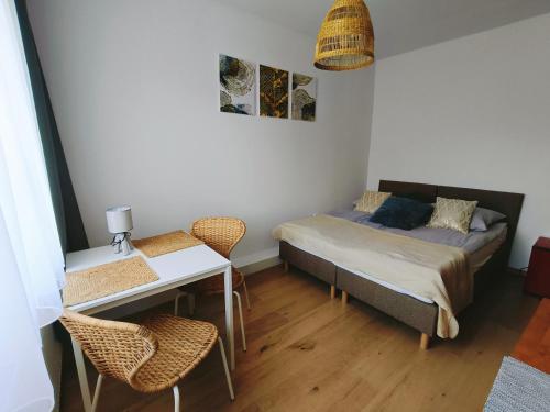 a room with a bed and a table and chairs at Cichy Zakątek in Sianozety