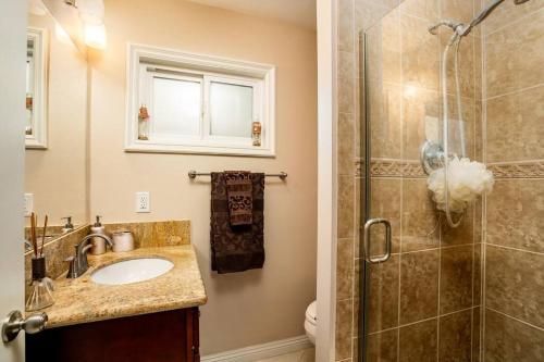 a bathroom with a sink and a shower at Coastal Family House! OC in Westminster