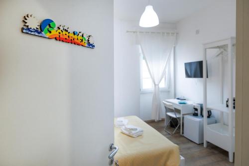 a room with a bed and a table in a room at La Fenice Suites Sardinia in Quartu SantʼElena