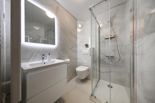 a bathroom with a shower and a sink and a toilet at Villa Gravic in Zadar