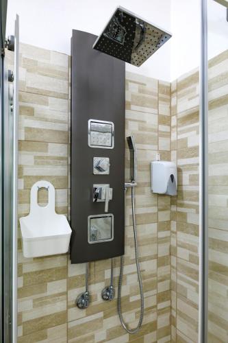 a bathroom with a shower and a sink at La Fenice Suites Sardinia in Quartu SantʼElena