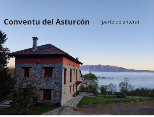a building on a hill with a view of the ocean at El Conventu del Asturcon in Lago