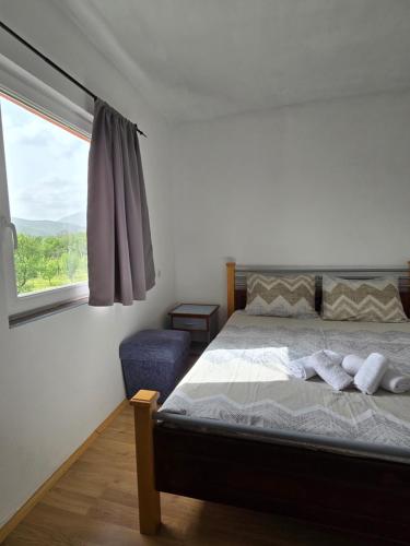a bedroom with a bed and a window at Rural Resort Tron - Rooms in Plužine