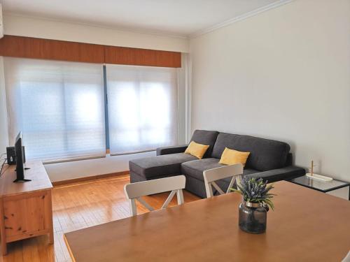 a living room with a couch and a table at Palácio Garden's House by LovelyStay in Porto