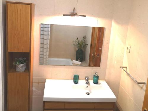 a bathroom with a white sink and a mirror at Palácio Garden's House by LovelyStay in Porto