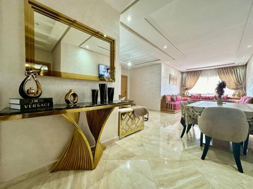 een eetkamer met een tafel en een spiegel bij superbe appartement en résidence balnéaire in Bouznika