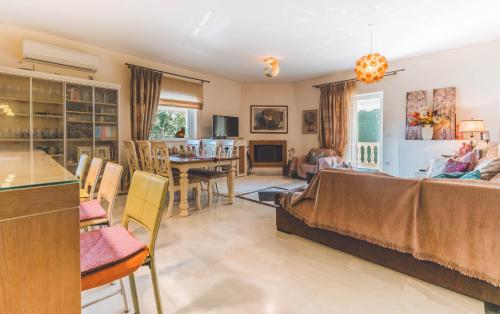 a living room with a couch and a dining room at Saint George Apartment in Preveza