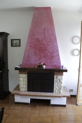 a fireplace with a red top in a living room at LA TANA DI TONY in Viterbo