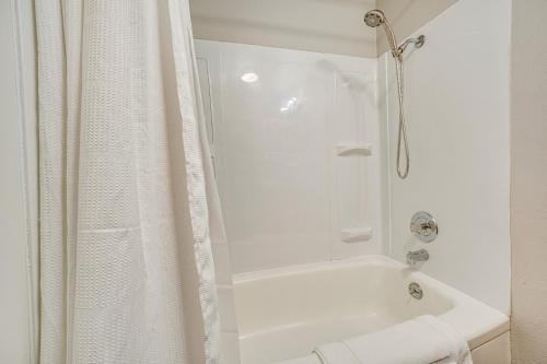 a white bathroom with a shower and a tub at Updated Yakima Vacation Rental Central Location! in Yakima