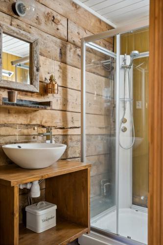 a bathroom with a sink and a shower at Sjøhaug Rorbu, Fishcermanns cabin in Moskenes