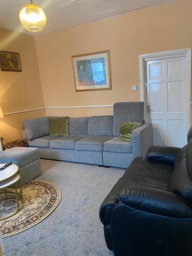 a living room with two couches and a couch at White and Sandstone Astley Bridg in Bolton