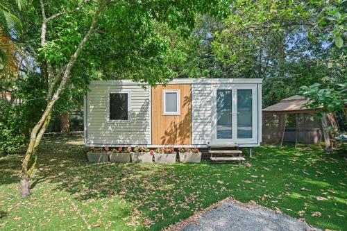 a tiny house sitting in the middle of a yard at Tiny Homes in the Heart of Fort Lauderdale in Fort Lauderdale