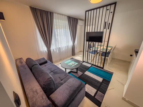 a living room with a couch and a table at Sunny Corner Apartments in Visoko