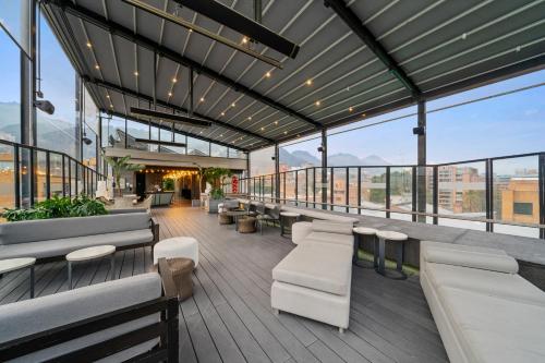 a building with benches and tables and windows at BOG Hotel in Bogotá