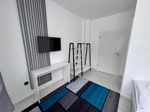 a white room with a television on a wall at Sunny Corner Apartments in Visoko