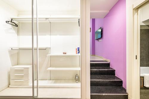 a walk in closet with purple walls and stairs at Luxury Apartments Pantheon Roma in Rome