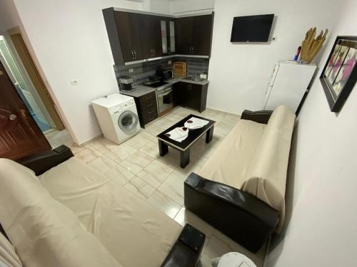 a living room with a couch and a table at Olive Tree Apartment in Sarandë