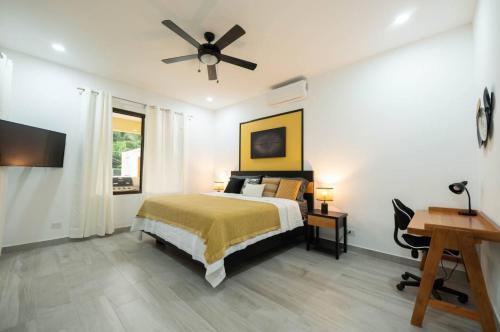a bedroom with a bed and a ceiling fan at Villa Alegra De Vivir By Vacation Pura Vida in Esterillos