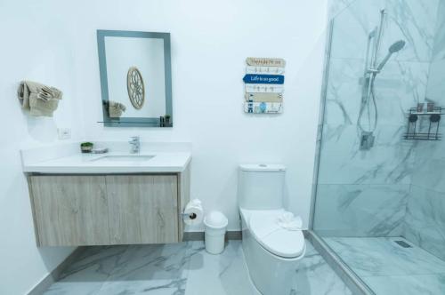 a bathroom with a toilet and a sink and a shower at Villa Alegra De Vivir By Vacation Pura Vida in Esterillos