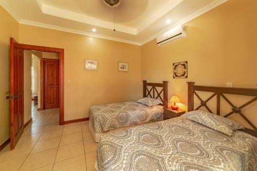 a bedroom with two beds in a room at Villa San Miguel By Vacation Pura Vida in Bejuco