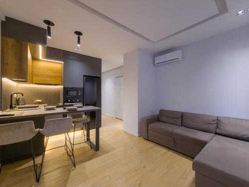 a living room with a couch and a table at PIN Apartments in Tirana
