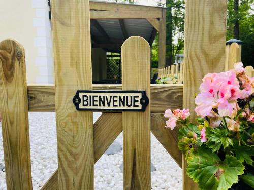 a wooden fence with a sign that reads beware at Au cœur des Bois in Amboise