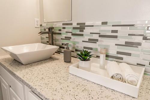a bathroom with a white sink and a counter at Private Waterfront Beach House with Fire-pit in Ocean Springs